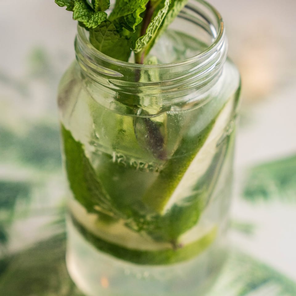 Mojito with mint and lime in a mason jar.
