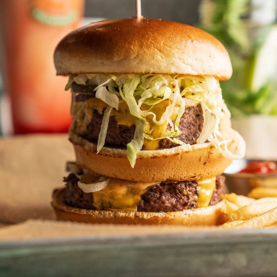 Double Kahuna Burger with cheese, lettuce, and fries.