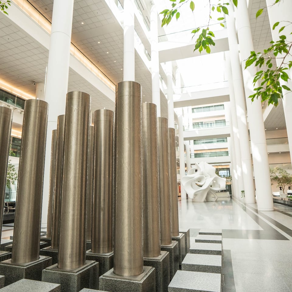 Metal column sculpture beneath the Garden Atrium's glass ceiling.